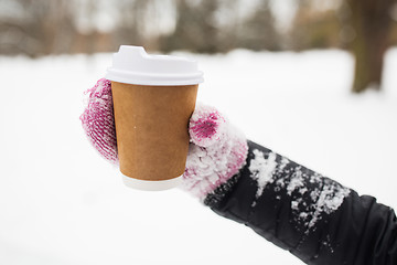 Image showing close up of hand with coffee outdoors in winter