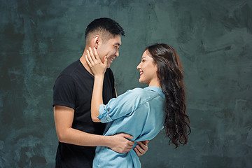 Image showing Portrait of smiling Korean couple on a gray