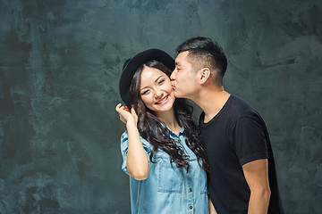 Image showing Portrait of smiling Korean couple on a gray