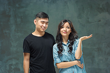 Image showing Portrait of smiling Korean couple on a gray