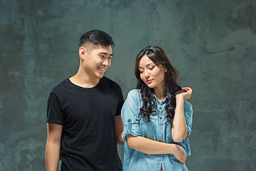 Image showing Portrait of smiling Korean couple on a gray