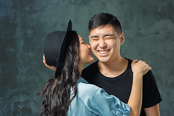 Image showing Portrait of smiling Korean couple on a gray