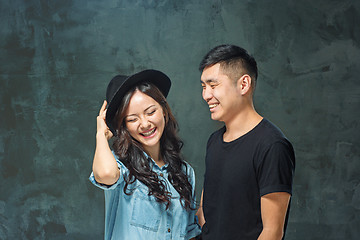 Image showing Portrait of smiling Korean couple on a gray