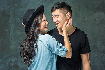 Image showing Portrait of smiling Korean couple on a gray