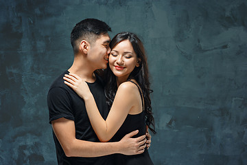 Image showing Portrait of smiling Korean couple on a gray