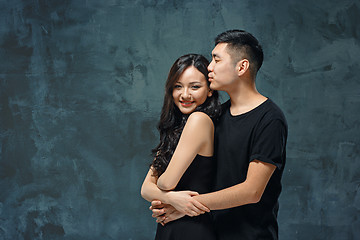 Image showing Portrait of smiling Korean couple on a gray