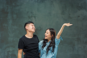 Image showing Portrait of smiling Korean couple on a gray