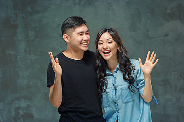 Image showing Portrait of smiling Korean couple on a gray