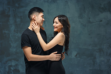 Image showing Portrait of smiling Korean couple on a gray