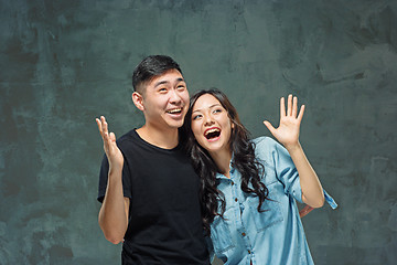 Image showing Portrait of smiling Korean couple on a gray