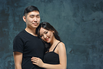 Image showing Portrait of smiling Korean couple on a gray