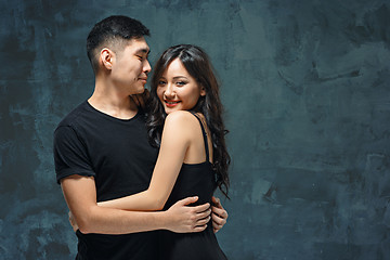 Image showing Portrait of smiling Korean couple on a gray