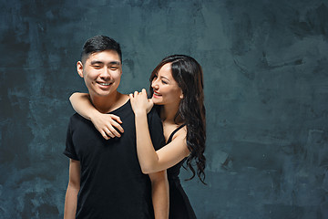 Image showing Portrait of smiling Korean couple on a gray