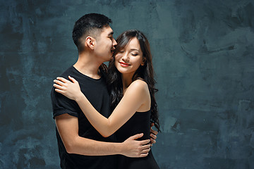 Image showing Portrait of smiling Korean couple on a gray