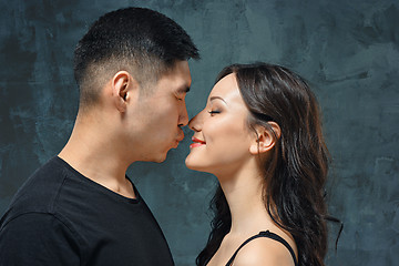 Image showing Portrait of smiling Korean couple on a gray