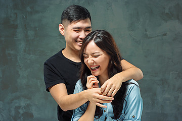 Image showing Portrait of smiling Korean couple on a gray