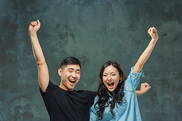 Image showing Portrait of smiling Korean couple on a gray