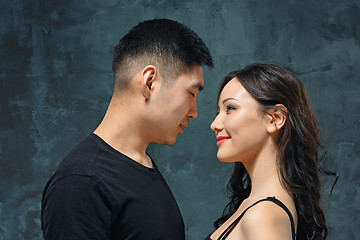 Image showing Portrait of smiling Korean couple on a gray