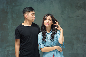 Image showing Portrait of smiling Korean couple on a gray