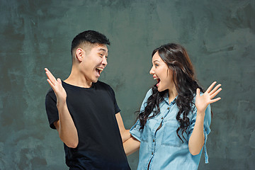 Image showing Portrait of smiling Korean couple on a gray