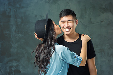 Image showing Portrait of smiling Korean couple on a gray