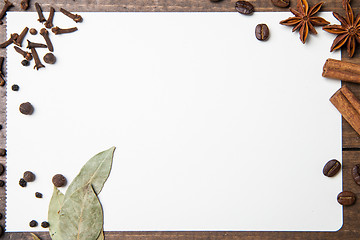 Image showing paper for recipes and spices on wooden table