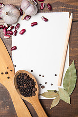 Image showing paper for recipes and spices on wooden table