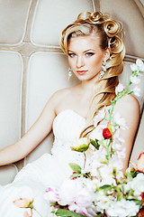 Image showing beauty young bride alone in luxury vintage interior with a lot of flowers close up