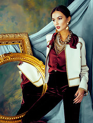Image showing beauty rich brunette woman in luxury interior near empty frames