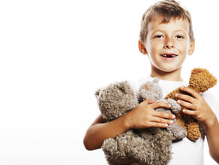 Image showing little cute boy with many teddy bears hugging isolated close up