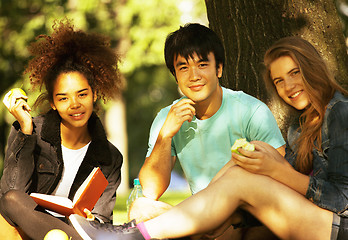 Image showing cute group of teenages at the building of university with books huggings