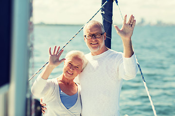 Image showing senior couple hugging on sail boat or yacht in sea