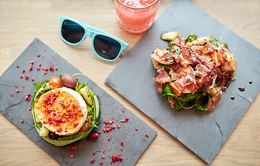 Image showing goat cheese and ham salads on cafe table