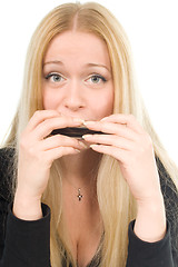 Image showing beautiful blond woman with a harmonica