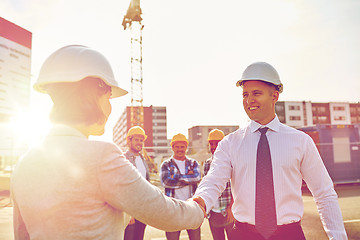 Image showing builders making handshake on construction site