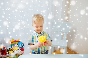 Image showing happy little baby boy with ball clay at home