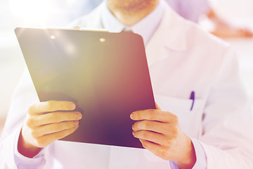 Image showing close up of doctor with clipboard at hospital