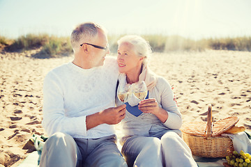 Image showing happy senior couple talking on summer beach