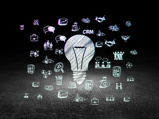 Image showing Finance concept: Light Bulb in grunge dark room