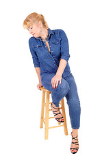 Image showing Blond woman sitting on chair.