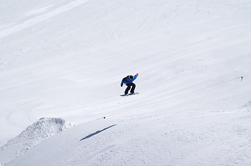 Image showing Snowboarder jumping in terrain park at ski resort on sun winter 