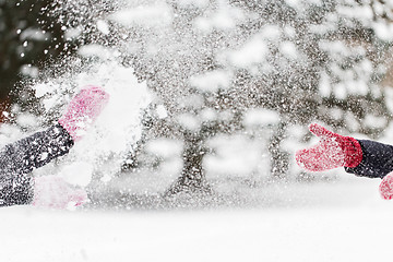 Image showing happy friends playing with snow in winter