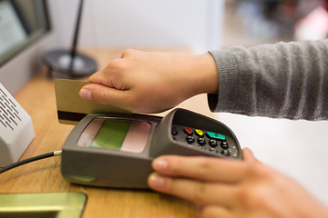 Image showing close up of hand inserting bank card to terminal