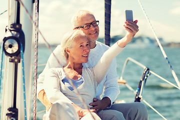 Image showing senior couple taking selfie on sail boat or yacht