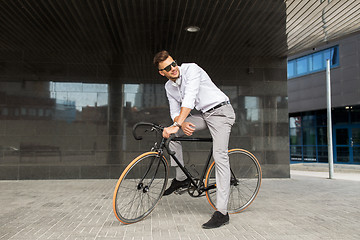 Image showing man with bicycle and headphones on city street