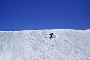 Image showing Snowboarder in terrain park and blue clear sky at ski resort