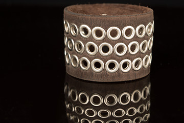 Image showing Brown leather bracelet isolated on a black