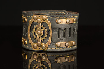 Image showing Brown leather bracelet isolated on a black