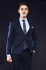 Image showing young pretty business man standing on black background, modern h