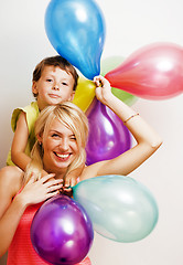 Image showing pretty family with color balloons on white background, blond woman with little boy at birthday